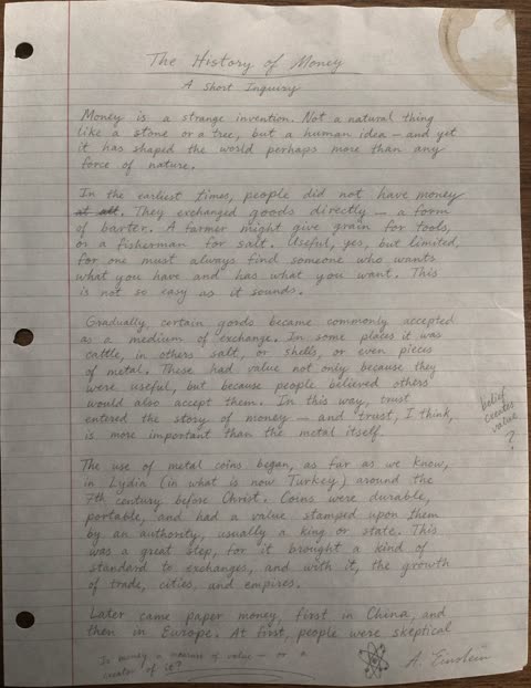 Pencil handwritten essay on lined paper with coffee stain