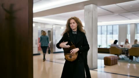 One take follows a woman from elevator to desk