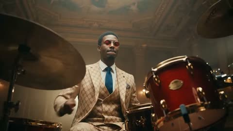 Whip-pan from drummer to saxophonist and dancer